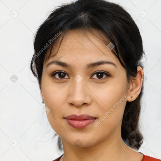 Joyful latino young-adult female with medium  brown hair and brown eyes