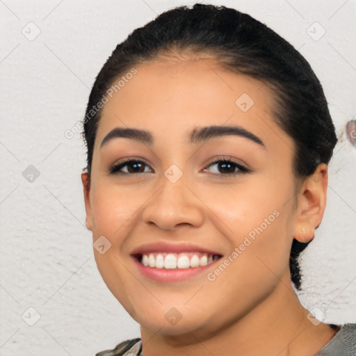 Joyful latino young-adult female with short  black hair and brown eyes