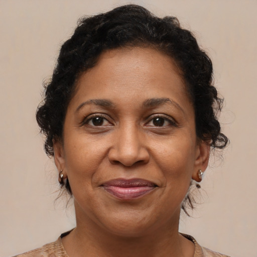 Joyful black adult female with medium  brown hair and brown eyes