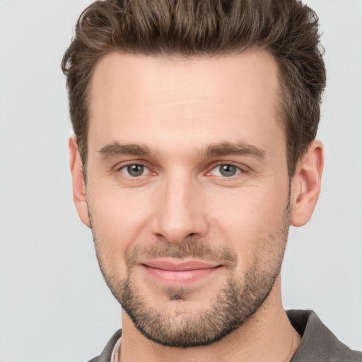 Joyful white young-adult male with short  brown hair and brown eyes