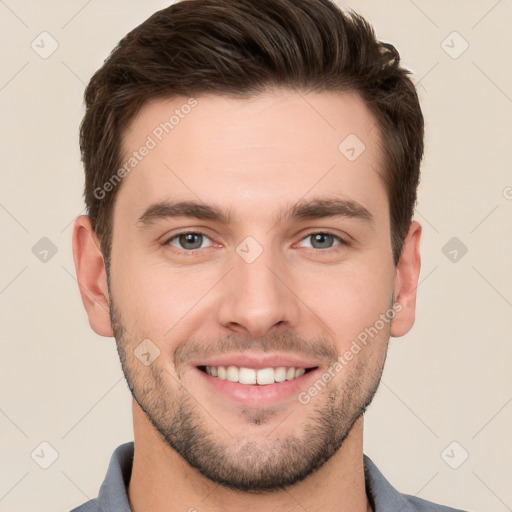 Joyful white young-adult male with short  brown hair and grey eyes