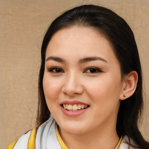 Joyful white young-adult female with long  brown hair and brown eyes