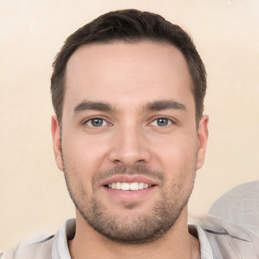 Joyful white young-adult male with short  black hair and brown eyes