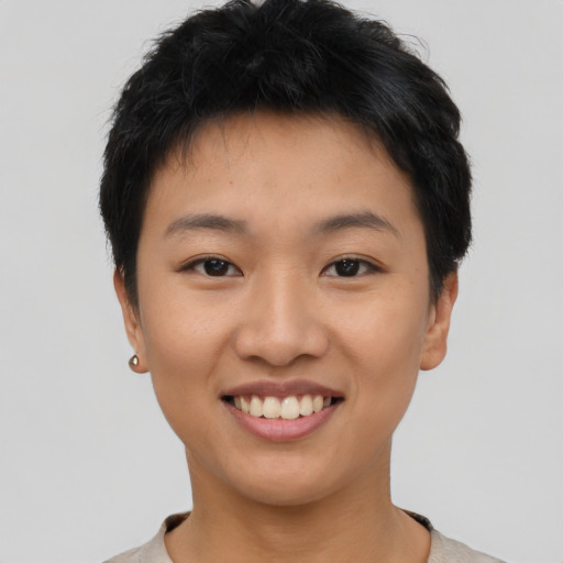 Joyful asian young-adult female with short  black hair and brown eyes