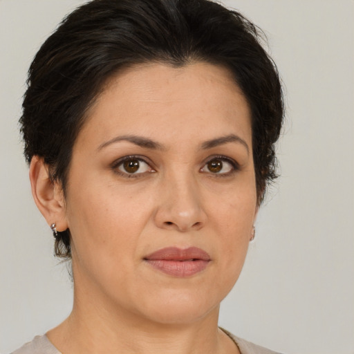 Joyful white adult female with medium  brown hair and brown eyes
