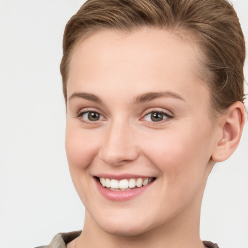 Joyful white young-adult female with short  brown hair and grey eyes