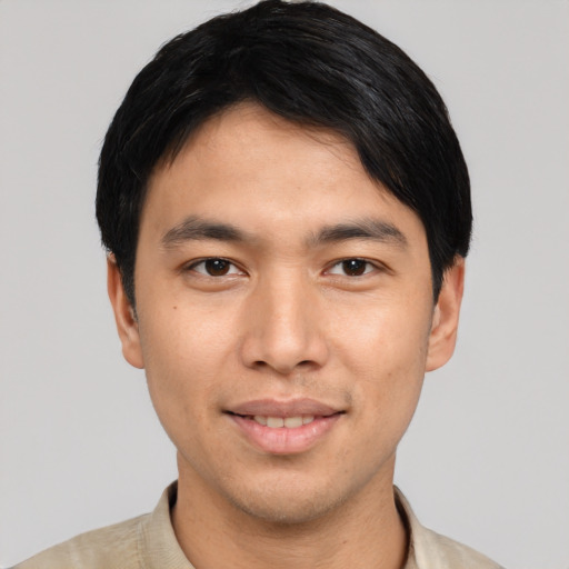 Joyful asian young-adult male with short  black hair and brown eyes