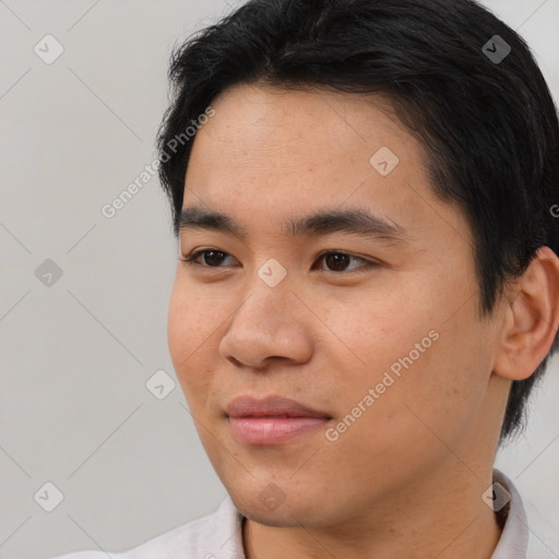 Joyful asian young-adult male with short  black hair and brown eyes