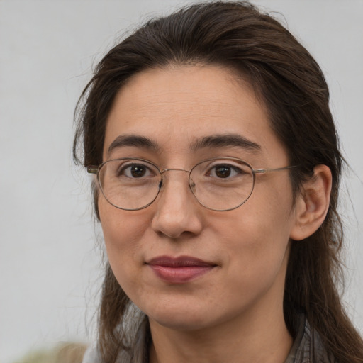 Joyful white adult female with long  brown hair and brown eyes