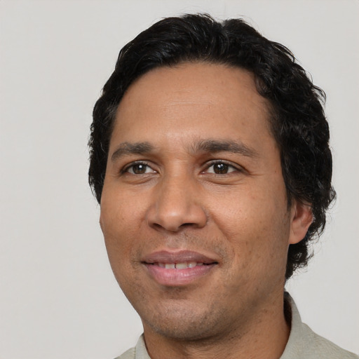 Joyful white adult male with short  black hair and brown eyes