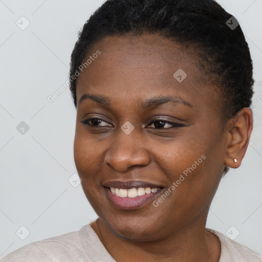 Joyful black young-adult female with short  brown hair and brown eyes