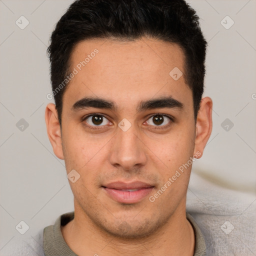 Joyful latino young-adult male with short  brown hair and brown eyes