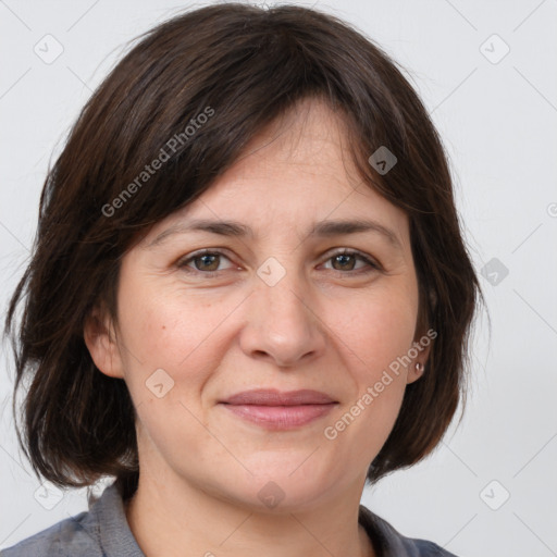 Joyful white adult female with medium  brown hair and grey eyes