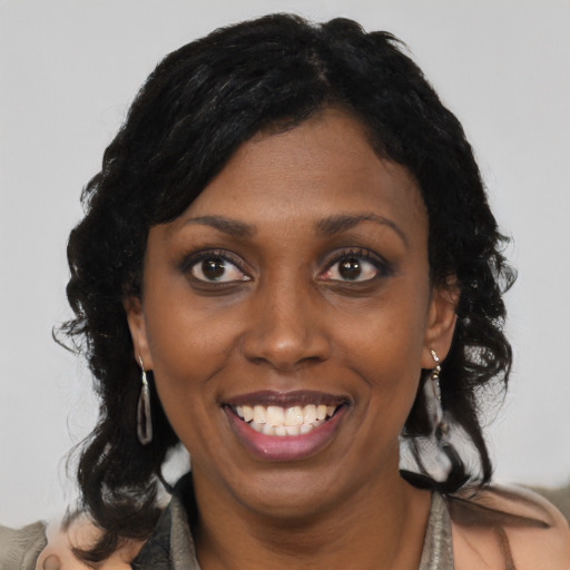 Joyful black young-adult female with medium  black hair and brown eyes