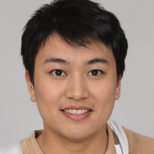 Joyful asian young-adult male with short  brown hair and brown eyes