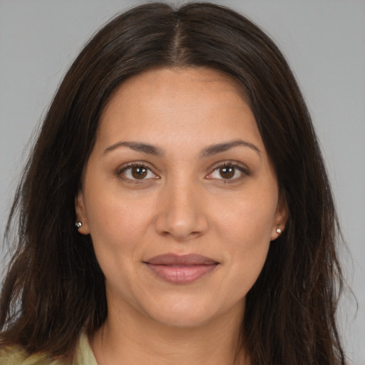 Joyful white adult female with long  brown hair and brown eyes
