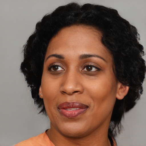 Joyful black adult female with medium  black hair and brown eyes