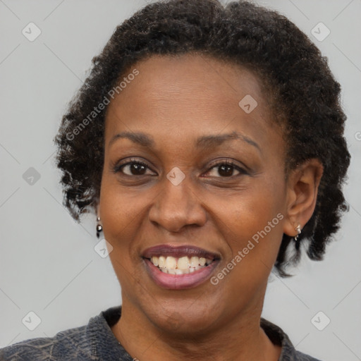 Joyful black adult female with short  brown hair and brown eyes