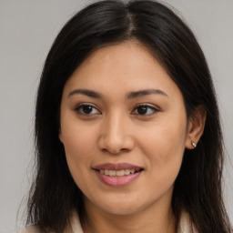 Joyful latino young-adult female with long  brown hair and brown eyes