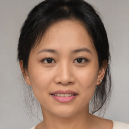 Joyful asian young-adult female with medium  brown hair and brown eyes