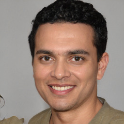 Joyful white young-adult male with short  black hair and brown eyes