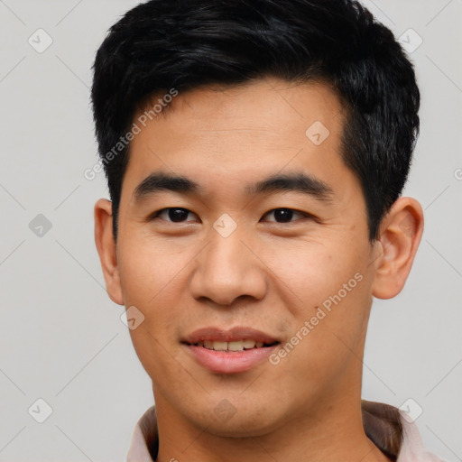 Joyful asian young-adult male with short  black hair and brown eyes