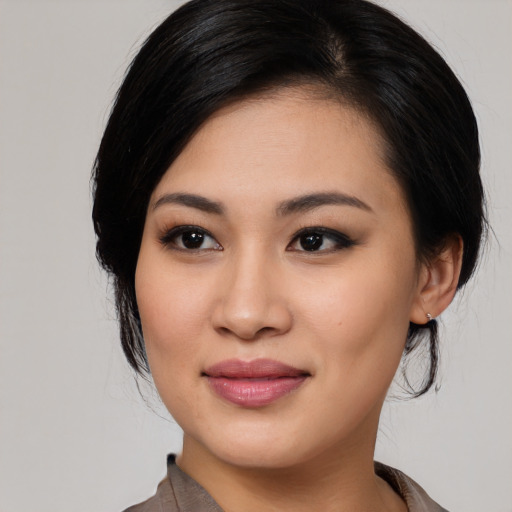 Joyful asian young-adult female with medium  black hair and brown eyes
