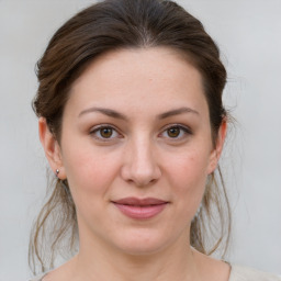 Joyful white young-adult female with medium  brown hair and grey eyes