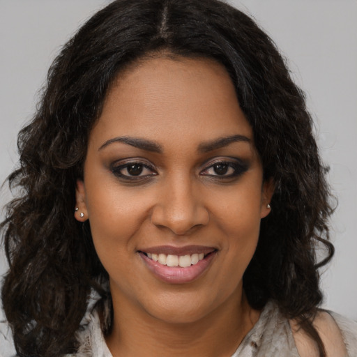 Joyful black young-adult female with long  brown hair and brown eyes