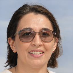 Joyful white adult female with medium  brown hair and brown eyes