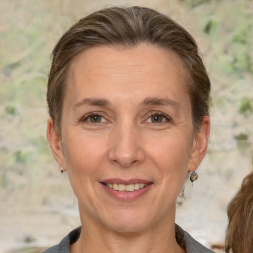 Joyful white adult female with medium  brown hair and brown eyes