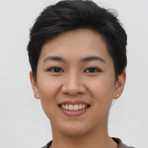 Joyful asian young-adult female with short  brown hair and brown eyes