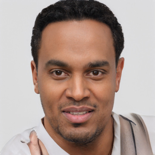 Joyful latino young-adult male with short  black hair and brown eyes