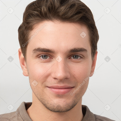 Joyful white young-adult male with short  brown hair and grey eyes