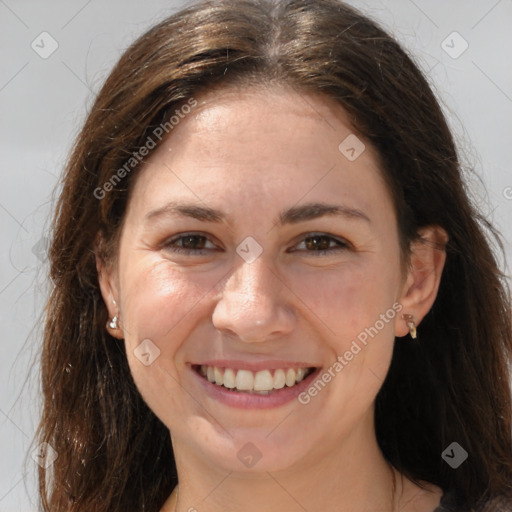 Joyful white adult female with long  brown hair and brown eyes