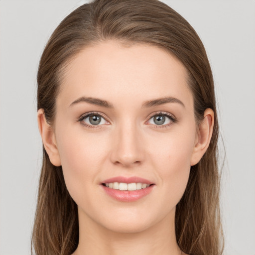 Joyful white young-adult female with long  brown hair and grey eyes