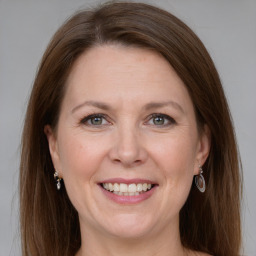 Joyful white adult female with medium  brown hair and grey eyes