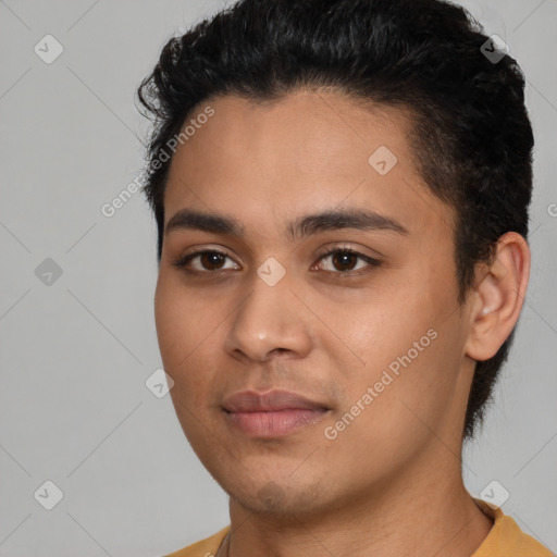 Joyful latino young-adult male with short  black hair and brown eyes