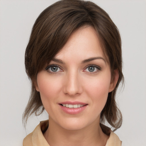 Joyful white young-adult female with medium  brown hair and grey eyes