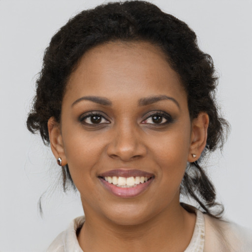 Joyful black young-adult female with medium  brown hair and brown eyes