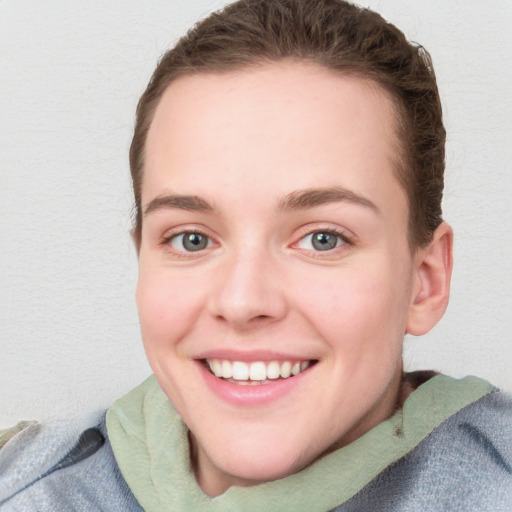 Joyful white young-adult female with long  brown hair and blue eyes