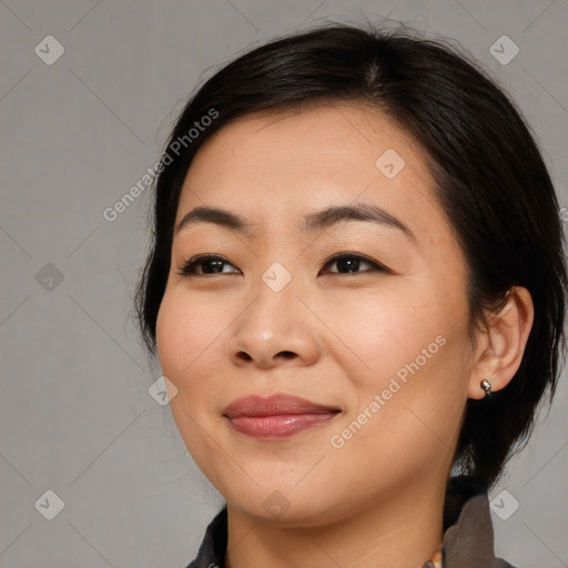 Joyful asian young-adult female with medium  black hair and brown eyes