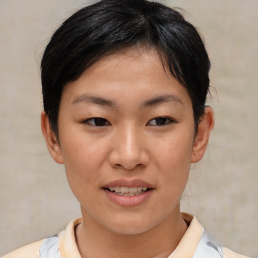 Joyful asian young-adult female with short  black hair and brown eyes