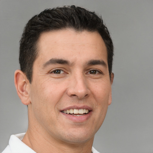 Joyful white adult male with short  brown hair and brown eyes