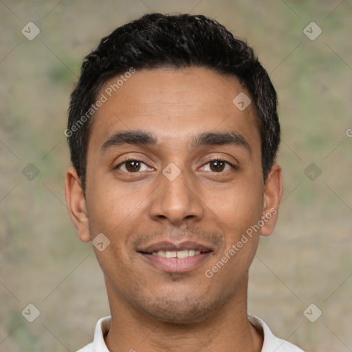 Joyful latino young-adult male with short  black hair and brown eyes