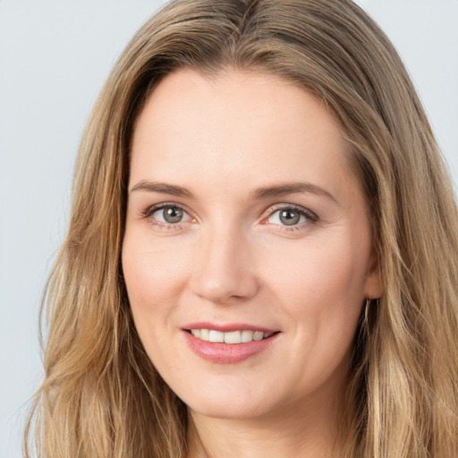 Joyful white young-adult female with long  brown hair and green eyes