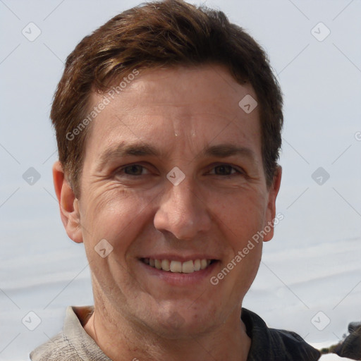 Joyful white adult male with short  brown hair and grey eyes