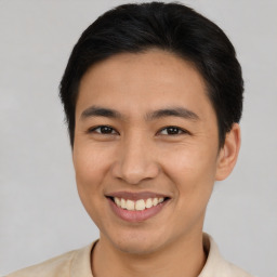 Joyful latino young-adult male with short  brown hair and brown eyes