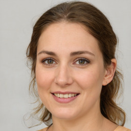 Joyful white young-adult female with medium  brown hair and green eyes