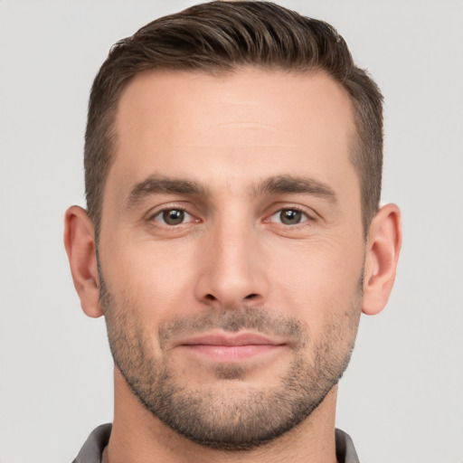 Joyful white young-adult male with short  brown hair and brown eyes